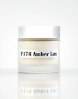 Jar of cream labeled 'F176 Amber Lux' on a white background