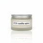 A jar of F73 vanilla spice aromatherapy body cream placed on a wooden surface with floral backgrounds.