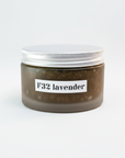 A jar of F32 Organic Lavender Aloe Exfoliate & Hydrate body scrub on a white surface with a label that reads 'F32 LAVENDER'.