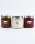 Three jars with silver lids and labeled numbers on a white background