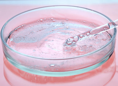 Image of skin serum in a petri dish being tested representing the science of epigenetics in skincare 