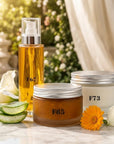 Formula Flawless F65 body polish, F67 Calle Lily body serum and F73 Vanilla Noir body cream together on white marble